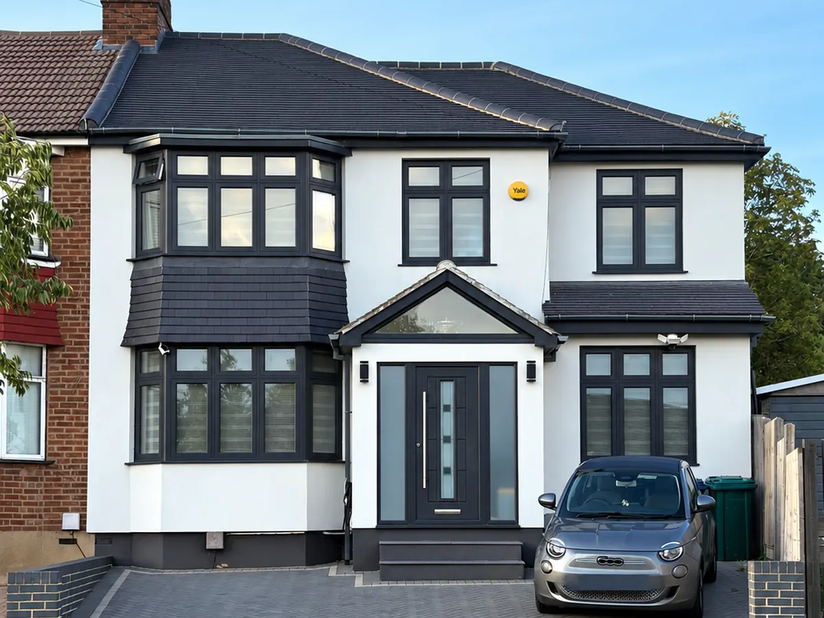 The same Barnet house finished in a white through-coloured silicone render with dark window frames
