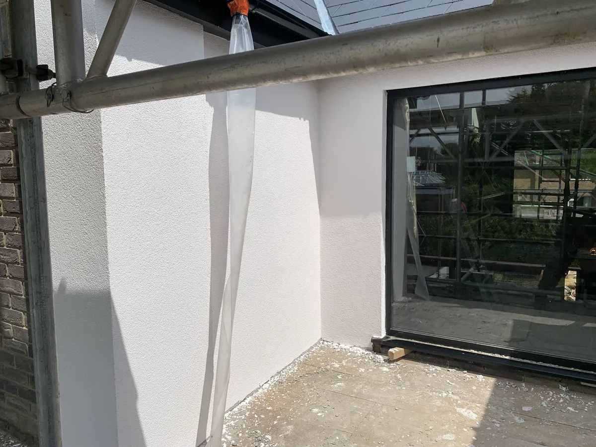 Rendered recess round a large window on a new build in Brentwood, finished in off-white render