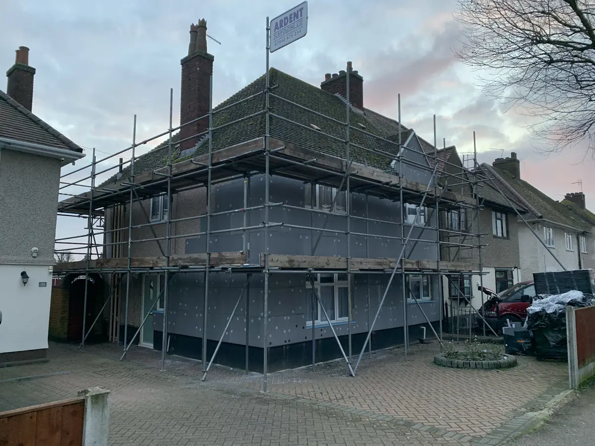 Insulation boards being fitted to a period semi-detached London home with scaffolding in place