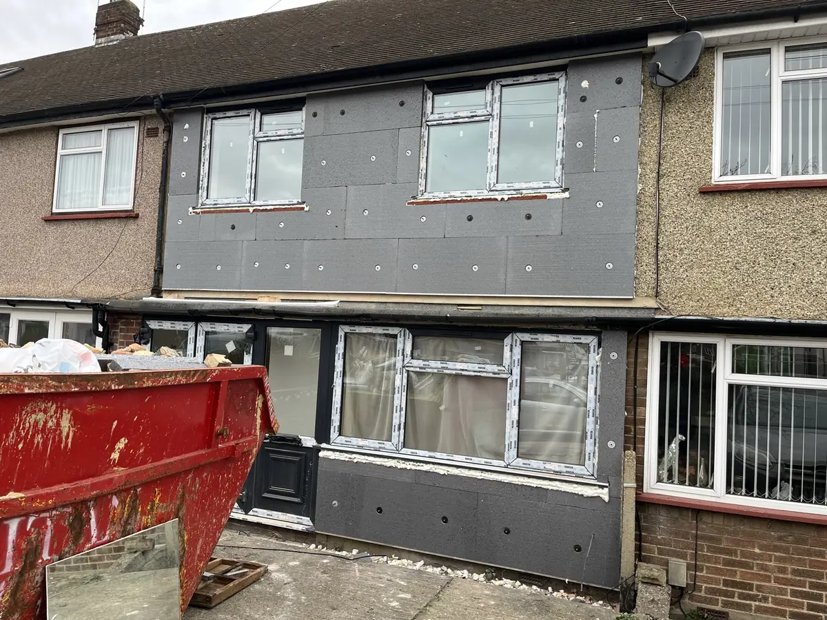 Insulation boards being fixed to the front elevation of a terraced house before rendering
