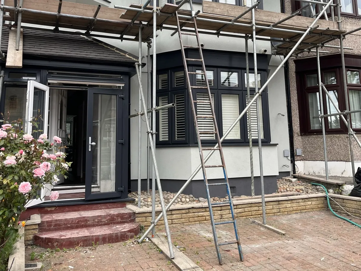 Ilford terrace under scaffolding with the new light grey render applied round the ground floor bay