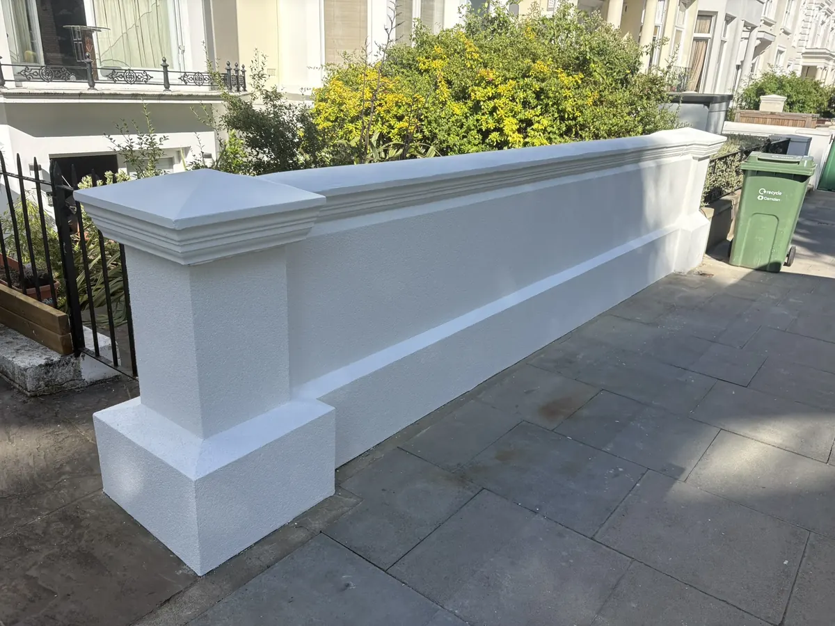 Newly rendered white front garden wall with moulded coping and pier in Belsize Park