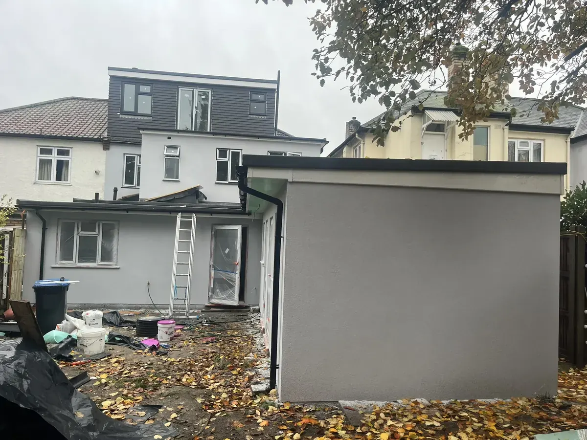 Finished grey render on a rear extension in Enfield Town with the house behind