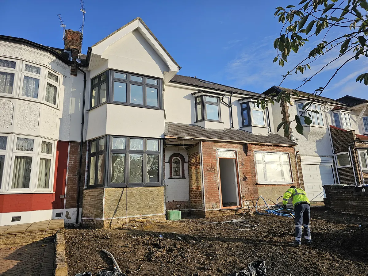 Period semi-detached house in Palmers Green mid-job, with the upper floor rendered and mesh and beads being set around the ground floor bay