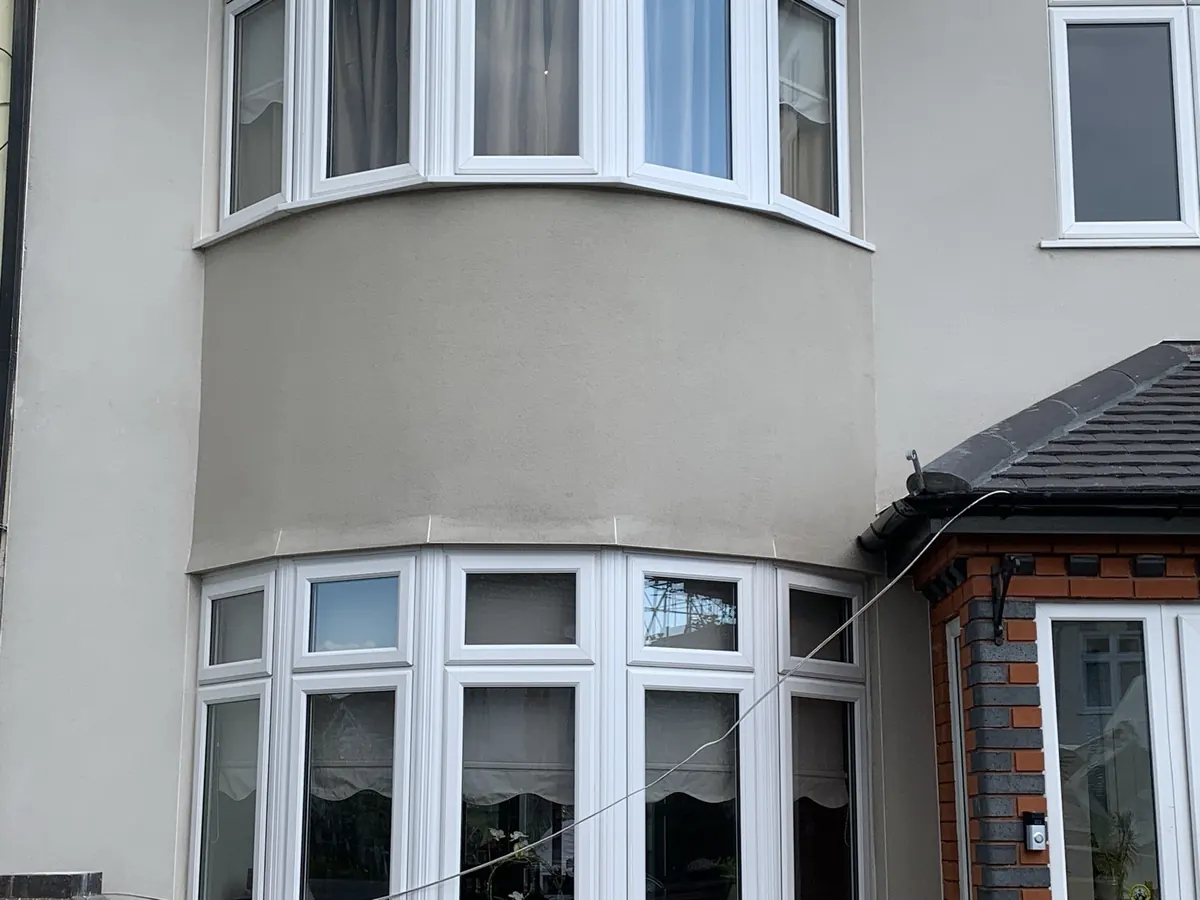 Curved two-storey bay on a South London semi with a smooth new render finish